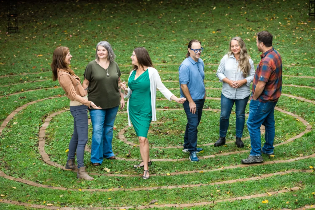 The staff of Widening Circles standing on grass