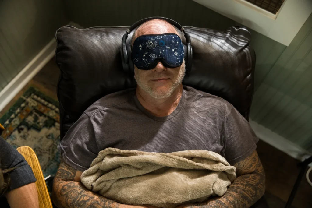 man with sleeping blind fold on