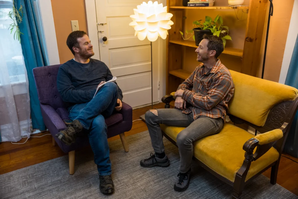 two men conversing in an office