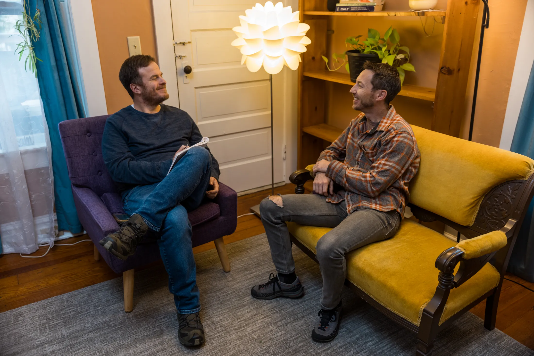 two men conversing in an office